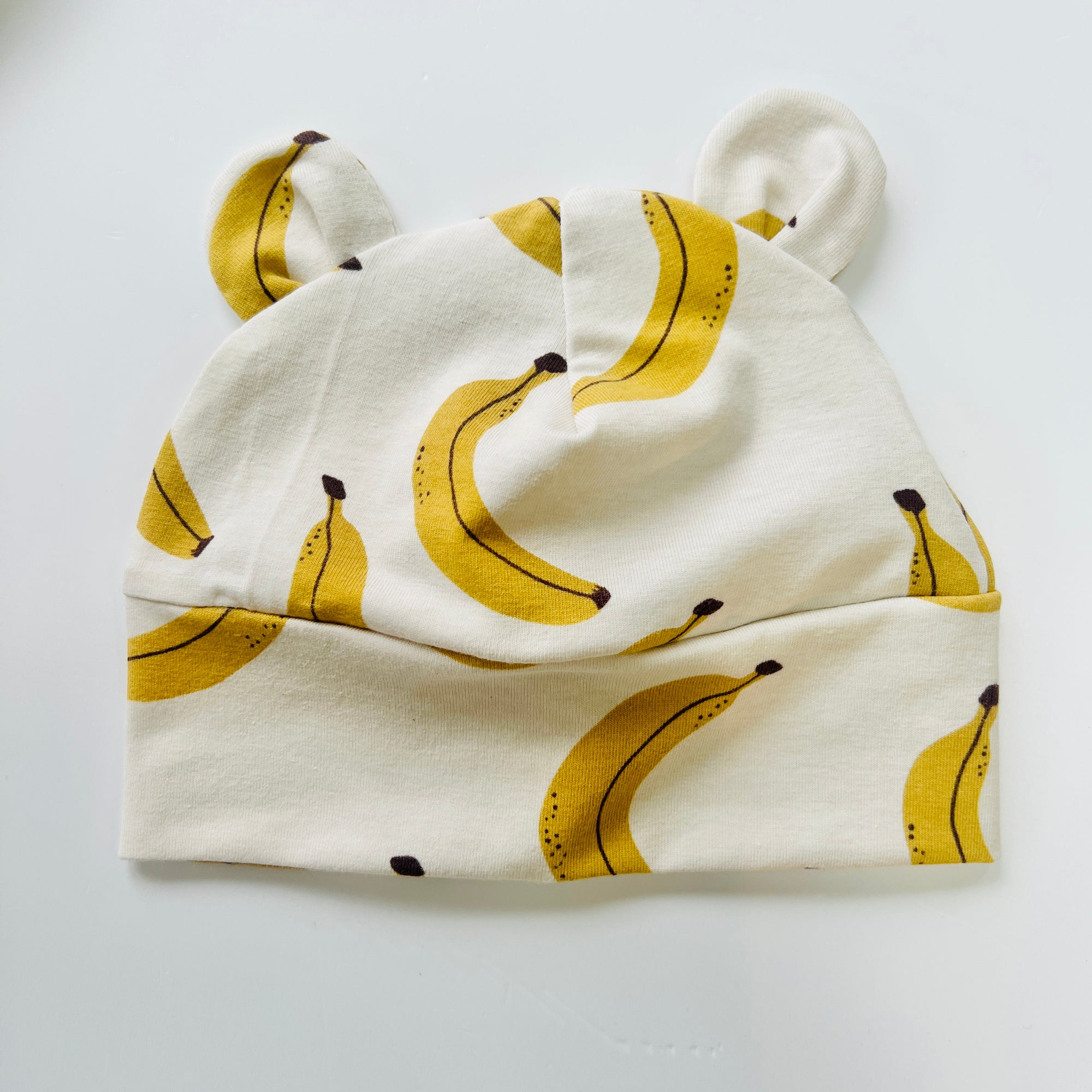 Eddie & Bee organic cotton Baby hat with ears  in Cream "Banana” print.