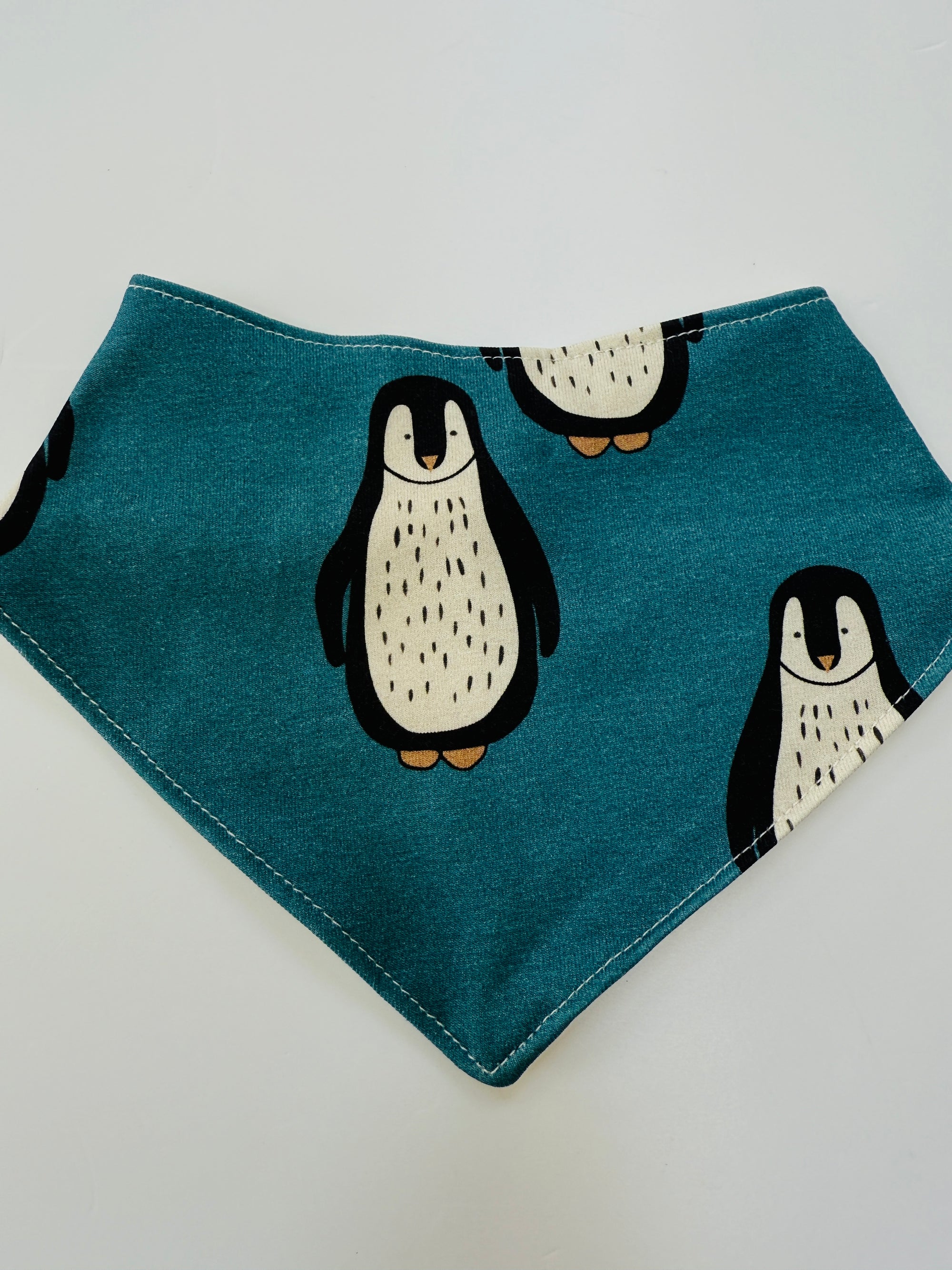 Eddie & Bee organic cotton Baby Dribble bib  in Teal "Penguin" print.
