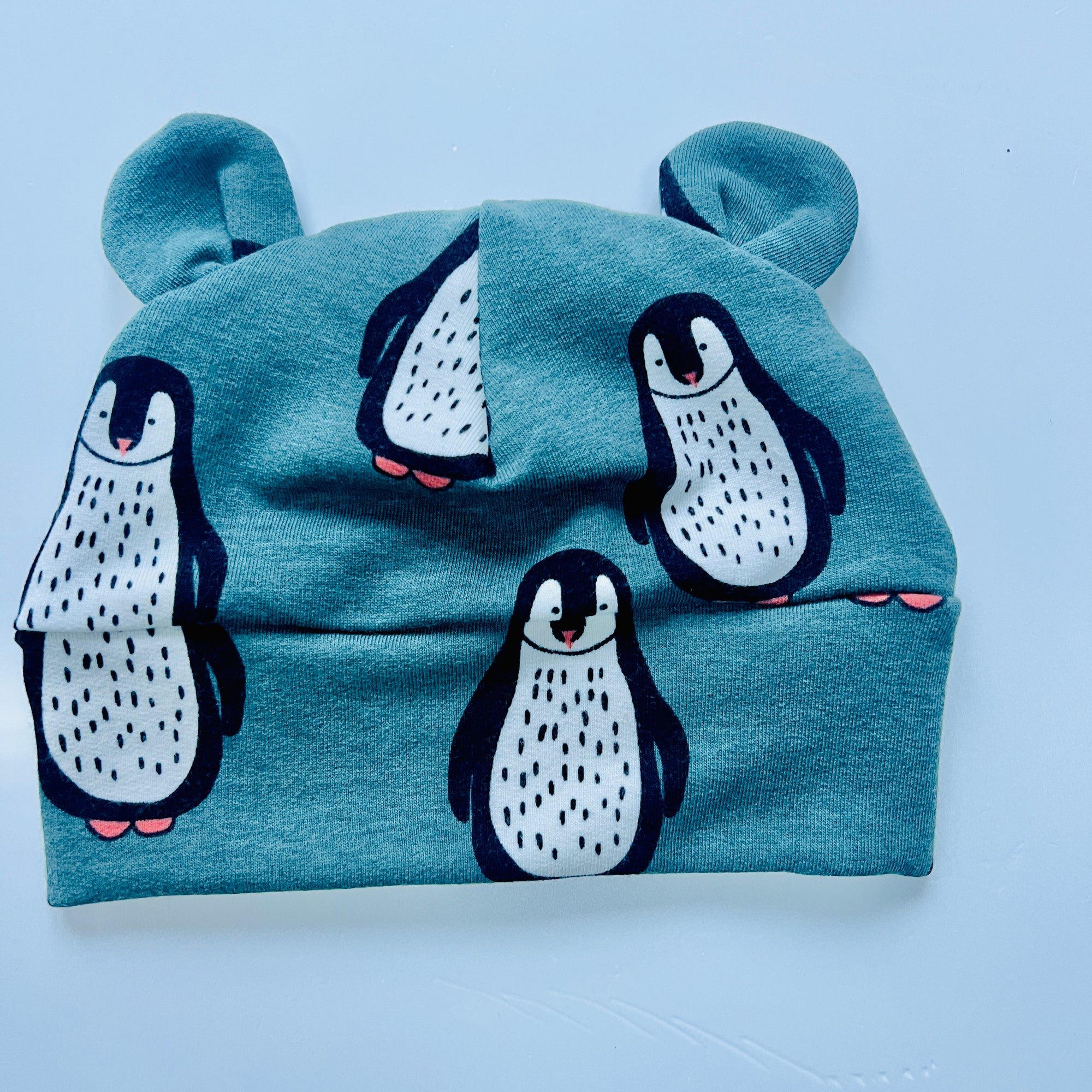 Eddie & Bee organic cotton Baby hat with ears  in Teal "Penguin" print. I