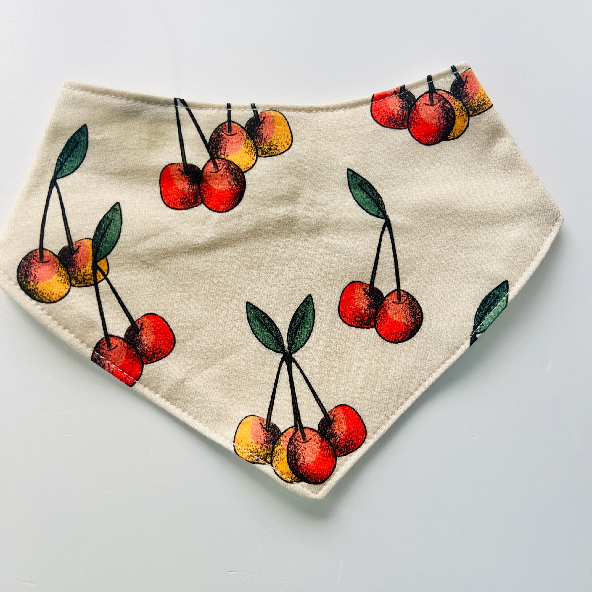 Eddie & Bee organic cotton Baby Dribble bib  in Butter Cream "Cherry" print.