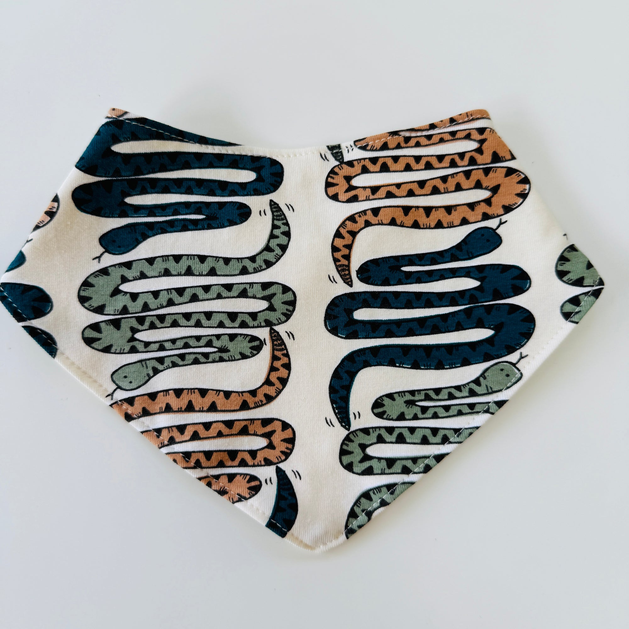 Eddie & Bee organic cotton Baby Dribble bib  in cream  "snakes” print.