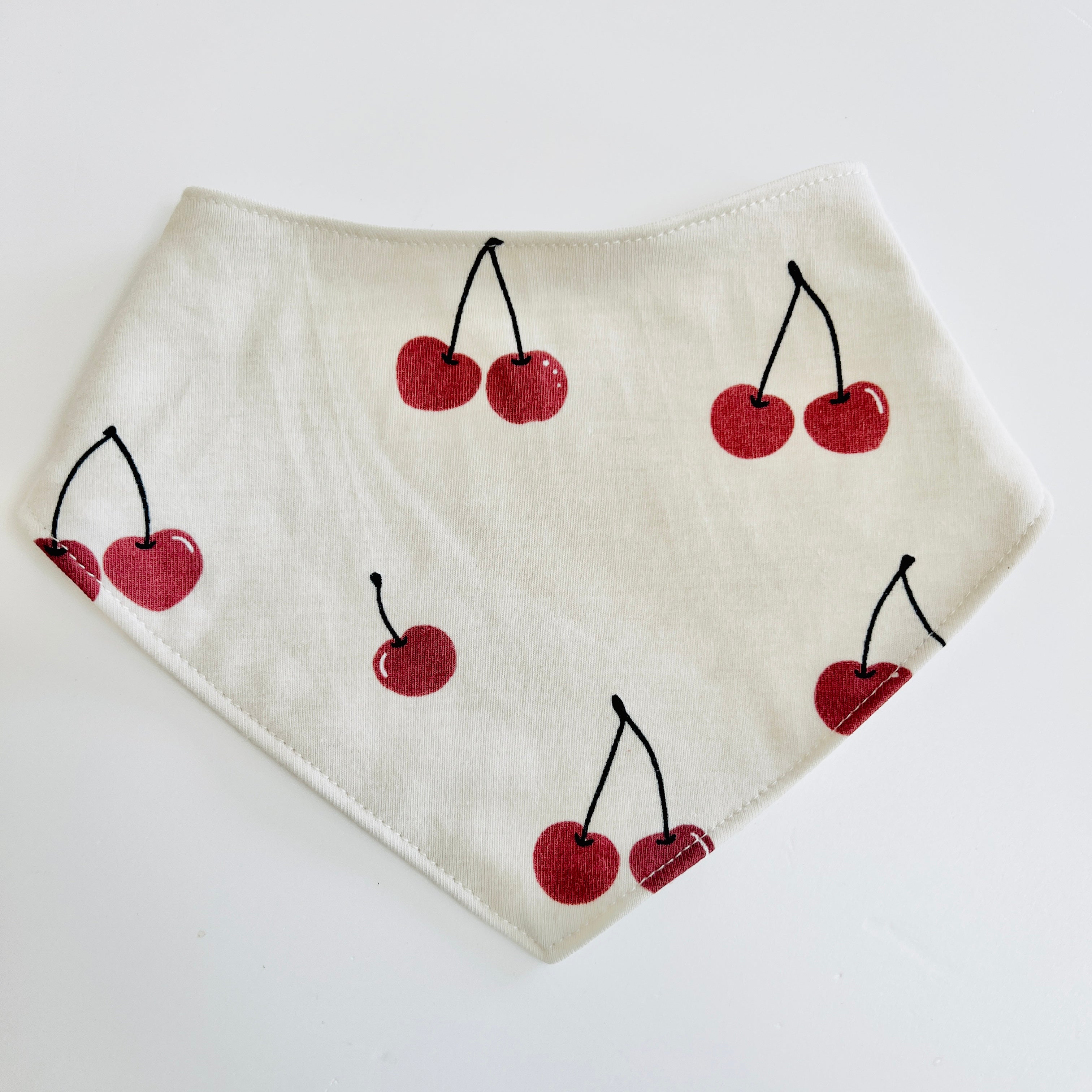 Eddie & Bee organic cotton Baby Dribble bib  in Oat "Cherries" print.